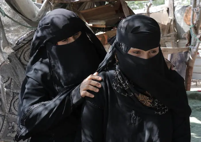 Married off to a much older man when she was only 16, Amina* (right) eventually escaped and returned home to her mother in a settlement near Aden, Yemen. A UNICEF-supported program helped her recover and learn skills to start a small business. 