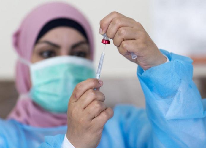 On May 3, 2020, nurse Hana Barakat fills a syringe at the Ministry of Health clinic in Ramallah, State of Palestine. 