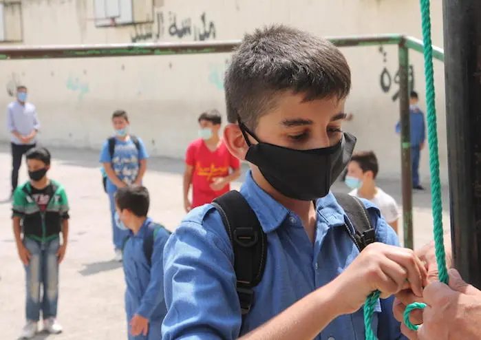 Boys line up on their first day back to school at Al Rasheed public school in Amman, Jordan.