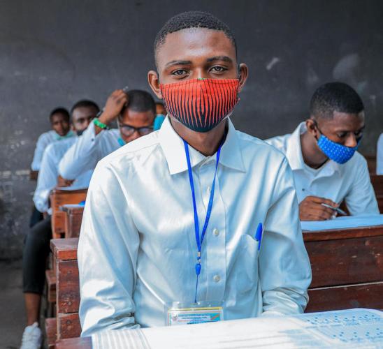 Justin, in his final year of secondary school in Kinshasa, DR Congo, sits for an exam.