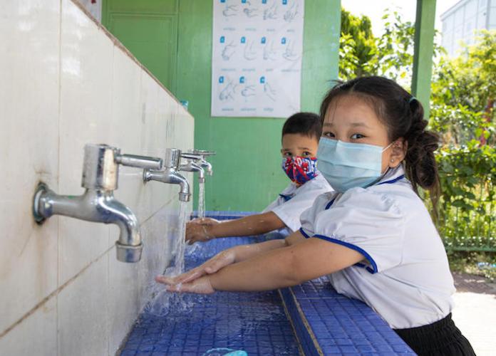 Students washing their hands during a break at Preah Norodom Primary School, Phnom Penh, Cambodia.