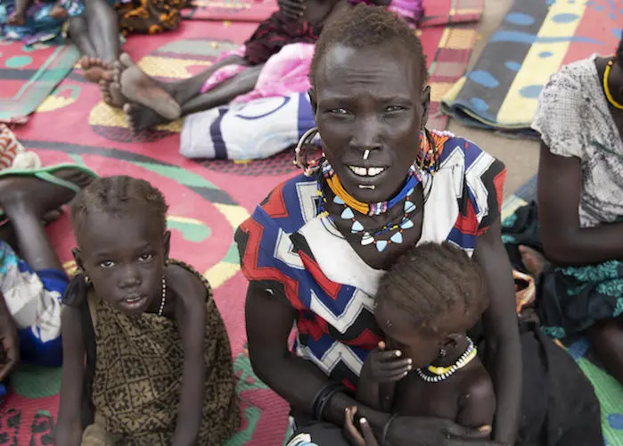Four-year-old Katalin, left, with her mother, Maze, and baby sister Kaka at a UNICEF-supported nutrition center in Pibor, South Sudan in September 2020.