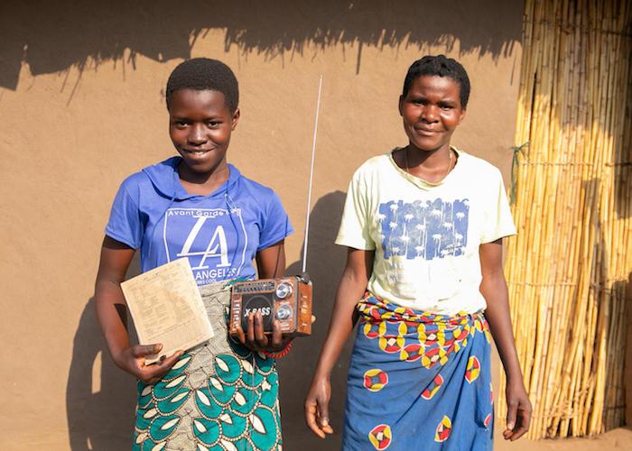 Sixteen-year-old Amina, above left with her aunt, Zainubu White, is continuing her education with UNICEF-supported lessons broadcast on the radio in Malawi. 