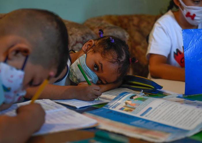 On 16 September 2020, children attend class in an improvised classroom in a house in Petare neighbourhood, Venezuela's largest slum, in Caracas, amid the COVID-19 pandemic.