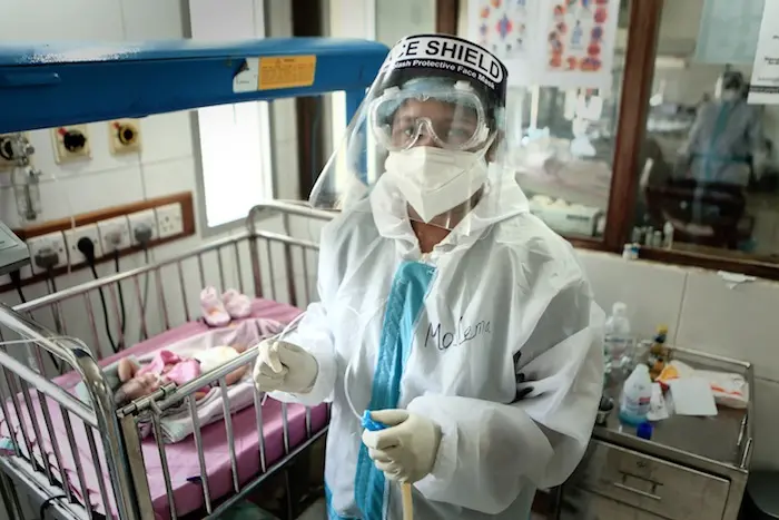 Nurse wearing a PPE getting ready to clean a baby’s nose inside the NICU. This photo was taken on 09 May 2020 at BSMMU in Dhaka, Bangladesh.