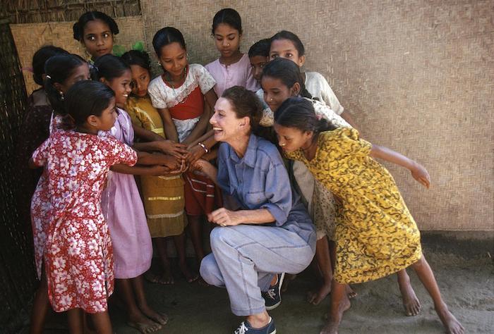 UNICEF Goodwill Ambassador Audrey Hepburn laughs with girls during a visit to Bangladesh in 1989.