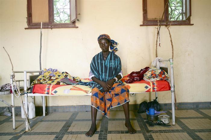 In Mali, a woman recovers in a hospital after suffering a ruptured uterus that resulted in the stillbirth of her baby.