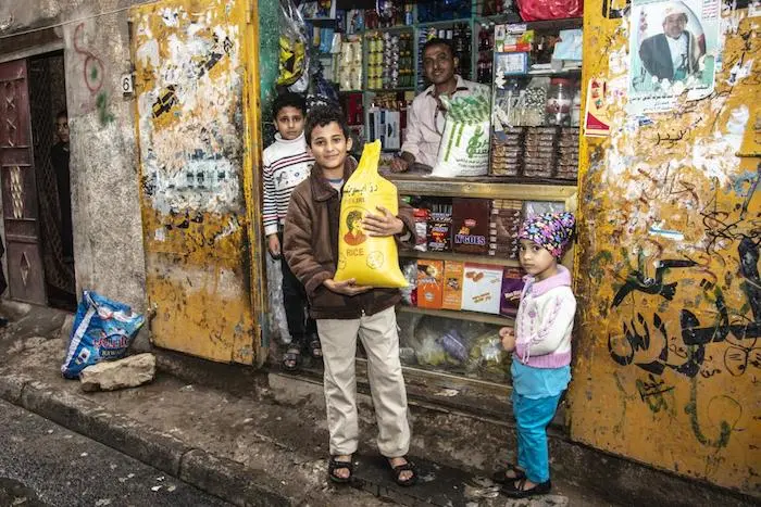 A boy in Sana'a, Yemen, is able to buy food thanks to support his family received from a UNICEF emergency cash transfer program.