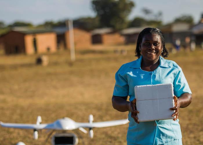 Community health worker Elizabeth Pemba holds lifesaving medical supplies delivered by UNICEF-supported drone in Malawi in 2019. 