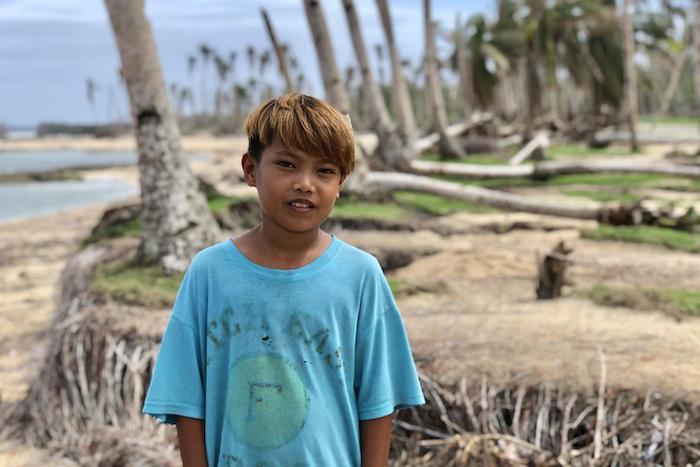 Reyn, 12, of Barangay Baybay, Burgos, Siargao, the Philippines, who received emergency water, sanitation and hygiene support from UNICEF after Typhoon Odette damaged his family's home.