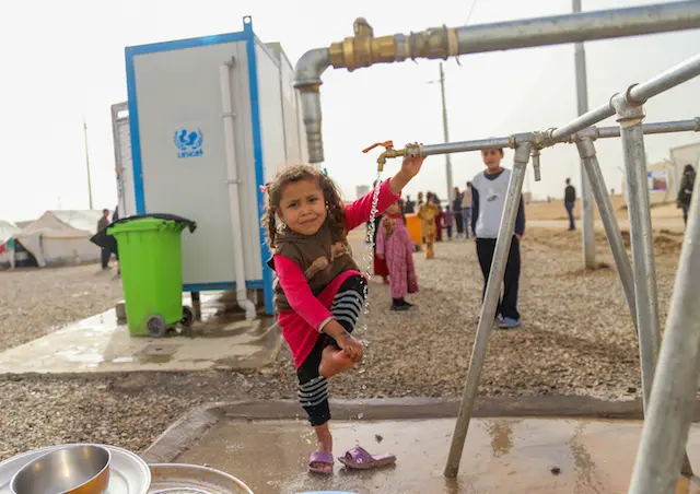 Four-year-old Athra was forced from her home in Mosul by escalating, violent conflict. Now she lives at the Debaga Camp in Erbil Governorate, Iraq, where she can wash at a UNICEF water tap. 