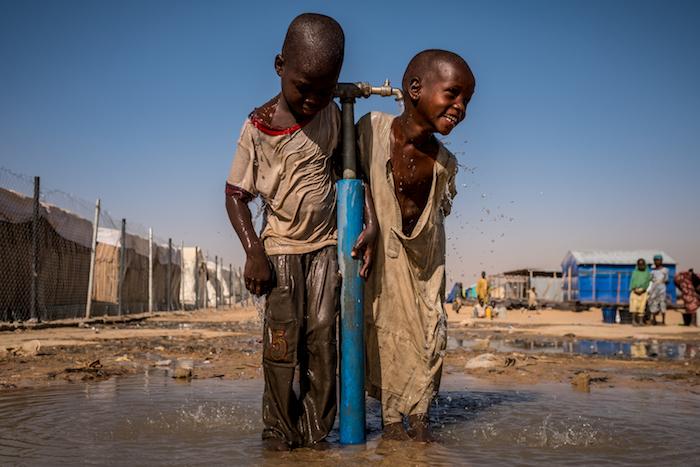 Children play at a water tap during recess at a UNICEF-supported primary school inside Bukasi Internally Displaced People's camp in Maiduguri, Borno State, Nigeria in February 2017.
