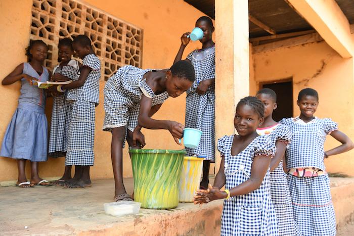 At school in Kouatoutou, Ivory Coast, 10-year-old Grohi washes her hands every day after classes and before dinner. 