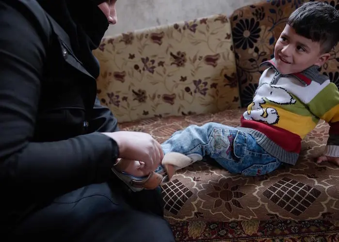 Haifa, 31, survived a bombing attack in Syria's rural Damascus governate. She is raising three children, including 3-year-old Mohammad, in the middle of Syria's civil war.