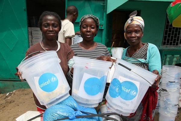In September 2014, women receive UNICEF hygiene kits in Monrovia, Liberia. 