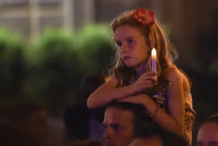 Child Holding Candle at Vigil