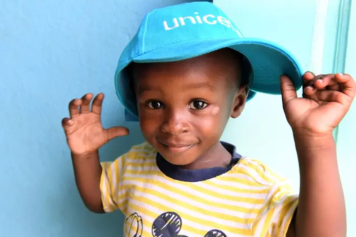 Israel, a 16 months old boy, is playing in the health center of Williamsville, where his pregnant mother came for a consultation.