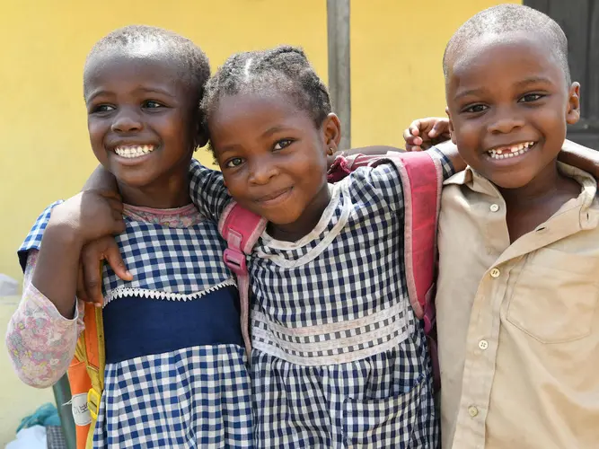 Happy friends leaving their UNICEF-supported school in Gonzagueville, a suburban of Abidjan, the capital of C&ocirc;te d'Ivoire, in 2019.