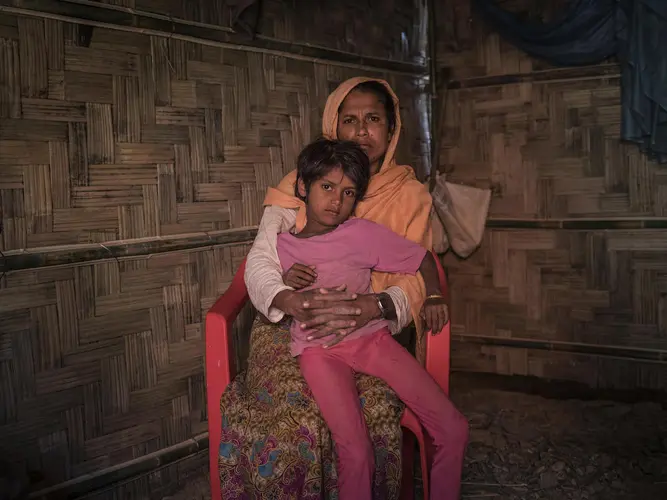 On 2 December 2019, Anjuma Bengum, 30, holds her daughter Lala Bibi, 5, at their home in Balukhali refugee camp in Cox&rsquo;s Bazar, Bangladesh. Anjuma&rsquo;s second daughter, Asma, 9, disappeared while on her way to buy groceries in the market.