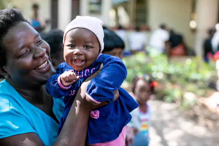 Person Holding Smiling Baby