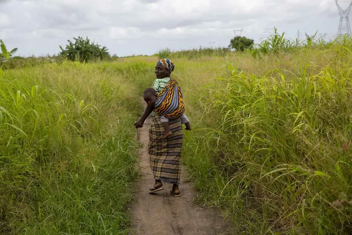 Maria Malo (32) carries her son Antonio Malo (1), after having received treatment at a UNICEF health centre in the Ndjenja Resettlement camp, Mozambique, Wednesday, 04 March 2020. After two major cyclones in one season, extreme drought and renewed floodin
