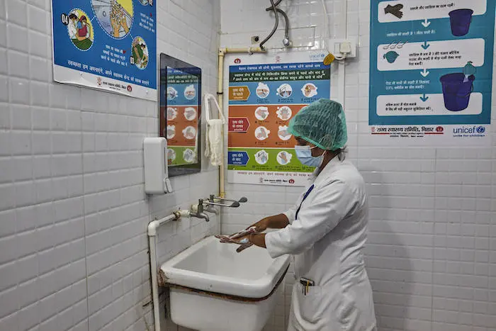 A nurse washes her hands before examining a patient at a hospital in Bhawanipur, Purnea, Bihar State, India. A nurse washes her hands before examining a patient at a hospital in Bhawanipur, Purnea, Bihar State, India.