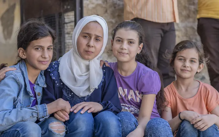 Four girls in a UNICEF-supported accelerated learning program for students who've missed out on school
