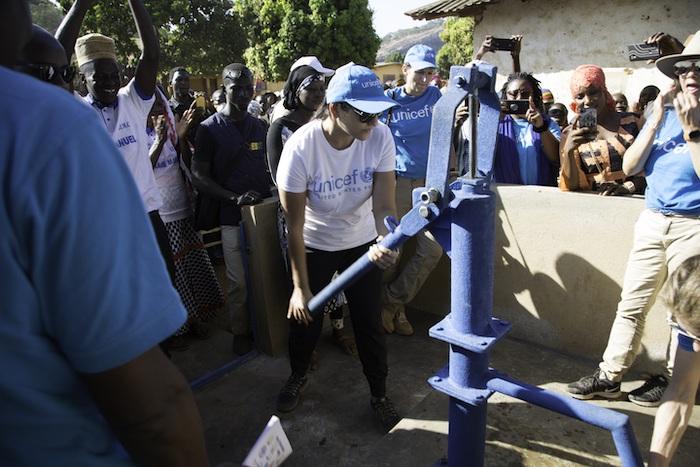 Dr. Sippi Khurana, UNICEF USA Houston regional board chair, tests a new safe water access point provided through UNICEF's Water for Guinea program during a recent field visit.