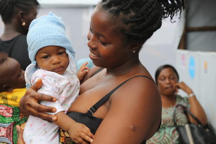 On 18 August, a woman and child in line for a consultation at the UNICEF-supported new health post at the temporary displacement center in the Regent community in Freetown, the capital of Sierra Leone.