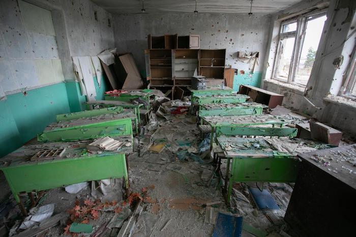Remnants of a classroom at a school that suffered heavy damage due to armed conflict in eastern Ukraine.