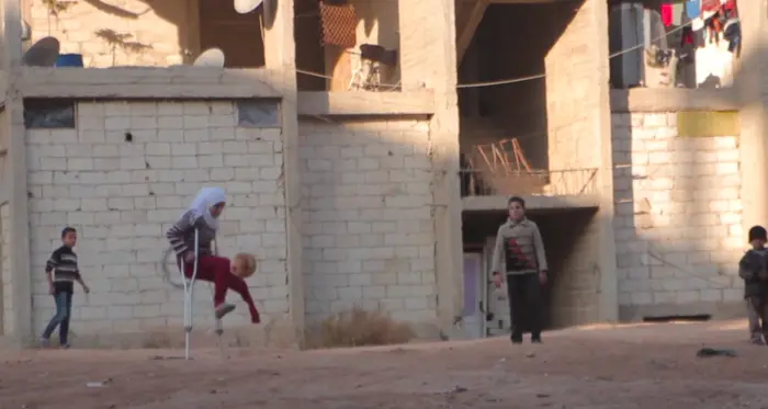 12-year-old Saja lost her leg in a bombing in her Syrian neighborhood and is now a refugee living at a camp in Aleppo.