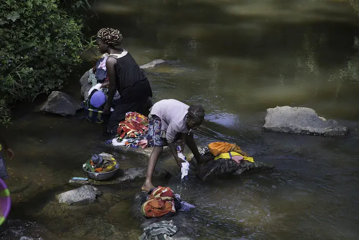 When communities draw drinking water from the same places where they wash their clothes, waterborne illnesses can spread.