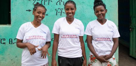 Three members of the gender club at Anka Primary School in SNNP region, Ethiopia, wear T-shirts that read, "Women's menstruation is not a curse but rather a natural gift."