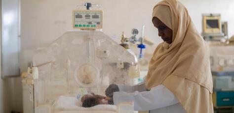 Sudan Auatf Mater Jaber, a pediatric nurse at UNICEF-supported Wad Madani Children's Hospital in Wad Madani, Gezira State, Sudan, tends to a sick baby in the neonatal unit. 