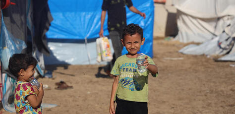 Yame , 5, holds bottled water delivered by UNICEF in a camp for displaced people in Khan Younis, southern Gaza, on Nov. 15, 2023.