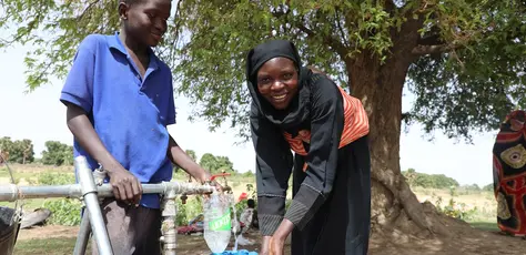 In June 2023, Mariam, a Sudanese refugee from the town of Tendelti, collects water from a borehole installed by UNICEF in the village of Koufroun, eastern Chad. 