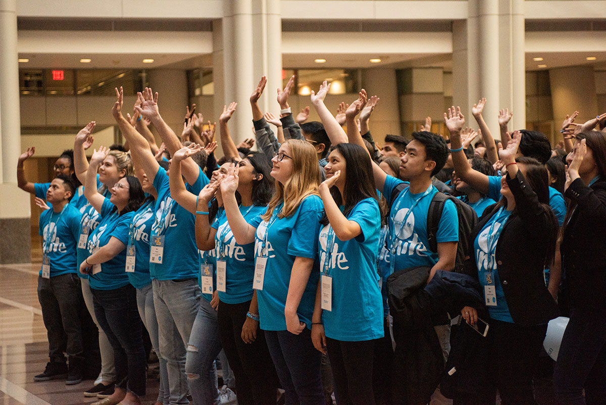 A group of high school UNITE volunteers wave hello